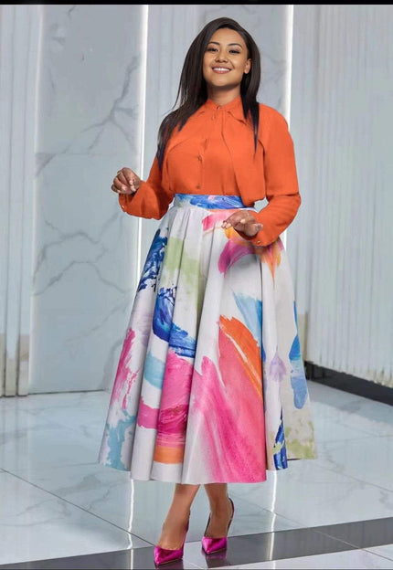 Orange long-sleeve button shirt with colorful watercolor midi skirt