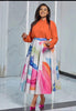 Orange long-sleeve button shirt with colorful watercolor midi skirt