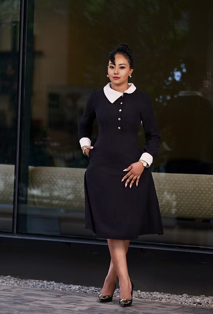 Dark midi dress with white Peter Pan collar, long sleeves, and gold button front