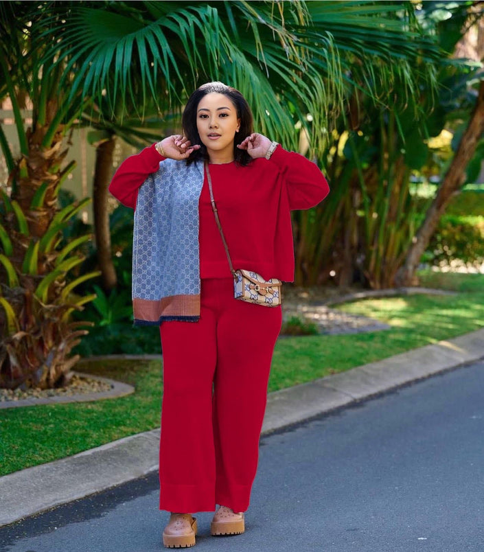 Red knit twin set with short cardigan, matching scarf, and wide-leg loose pants