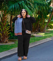 Black knit twin set with short cardigan, matching scarf, and wide-leg loose pants