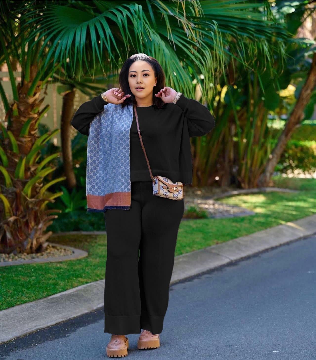 Black knit twin set with short cardigan, matching scarf, and wide-leg loose pants