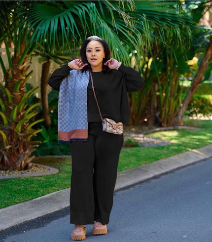 Black knit twin set with short cardigan, matching scarf, and wide-leg loose pants