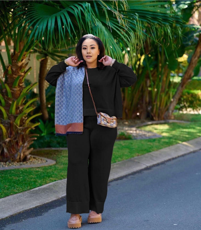 Black knit twin set with short cardigan, matching scarf, and wide-leg loose pants