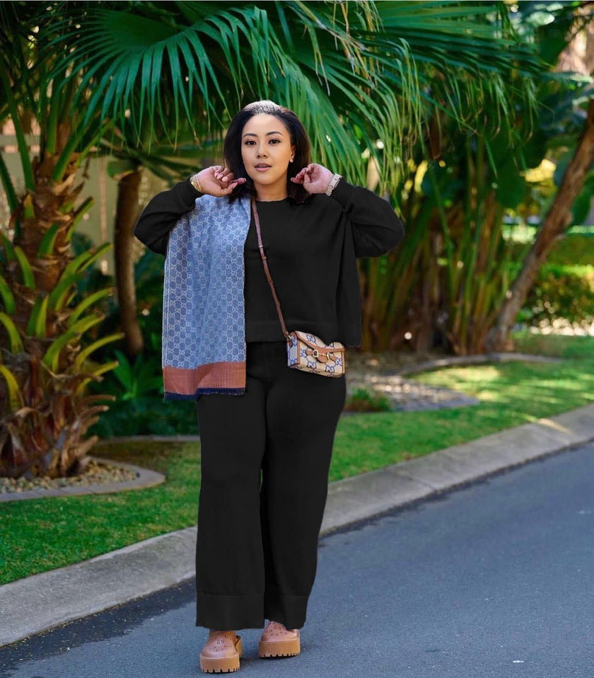 Black knit twin set with short cardigan, matching scarf, and wide-leg loose pants