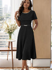 Black midi dress with chain neckline, short cap sleeves, and cinched waist belt