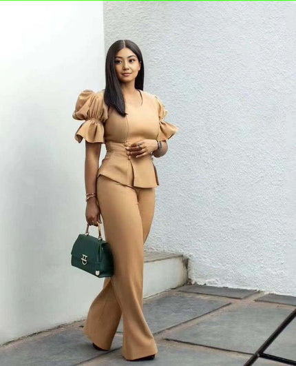 Nude tan puff-sleeve twin set with cropped peplum top and wide-leg pants.