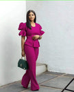 Magenta puff-sleeve twin set with cropped peplum top and wide-leg pants.