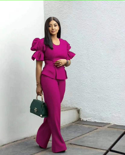 Magenta puff-sleeve twin set with cropped peplum top and wide-leg pants.
