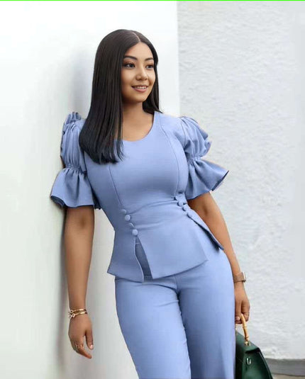Sky-blue puff-sleeve twin set with cropped peplum top and wide-leg pants.