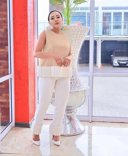 Light ivory fringe pant with slim fit and scalloped ruffle hem detail at the cuffs