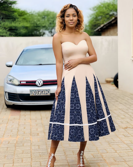 Cream strapless midi dress with blue patchwork skirt and tiered hem