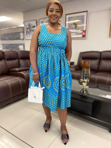 Blue patterned midi dress with square neckline, tiered skirt, and gathered waist