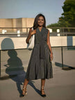 Sleeveless striped A-line midi dress with cross V neckline, dark vertical stripes