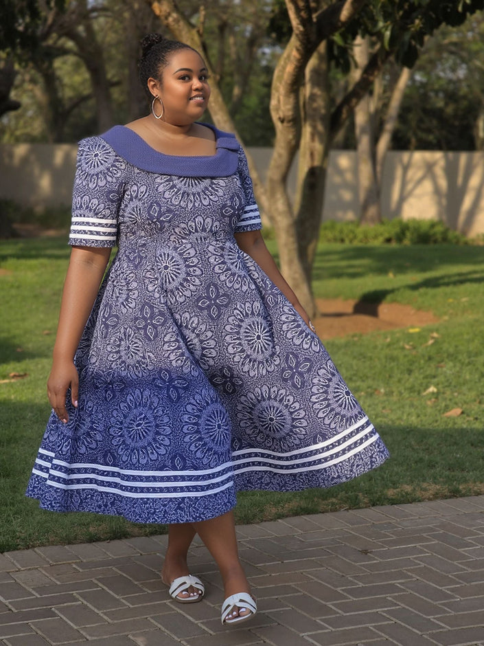 Blue midi dress with circular floral print, off-shoulder neckline and short sleeves