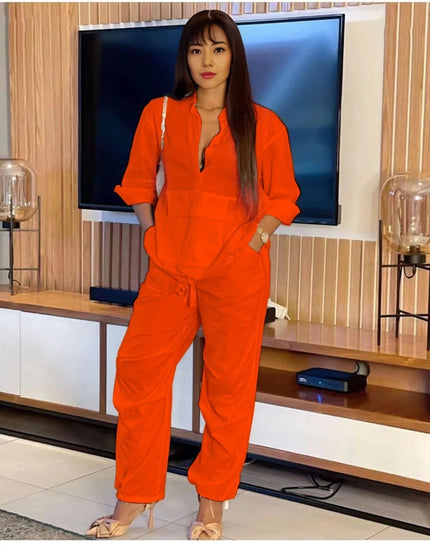 Orange-red solid color jumpsuit with front placket and drawstring waist, long sleeves