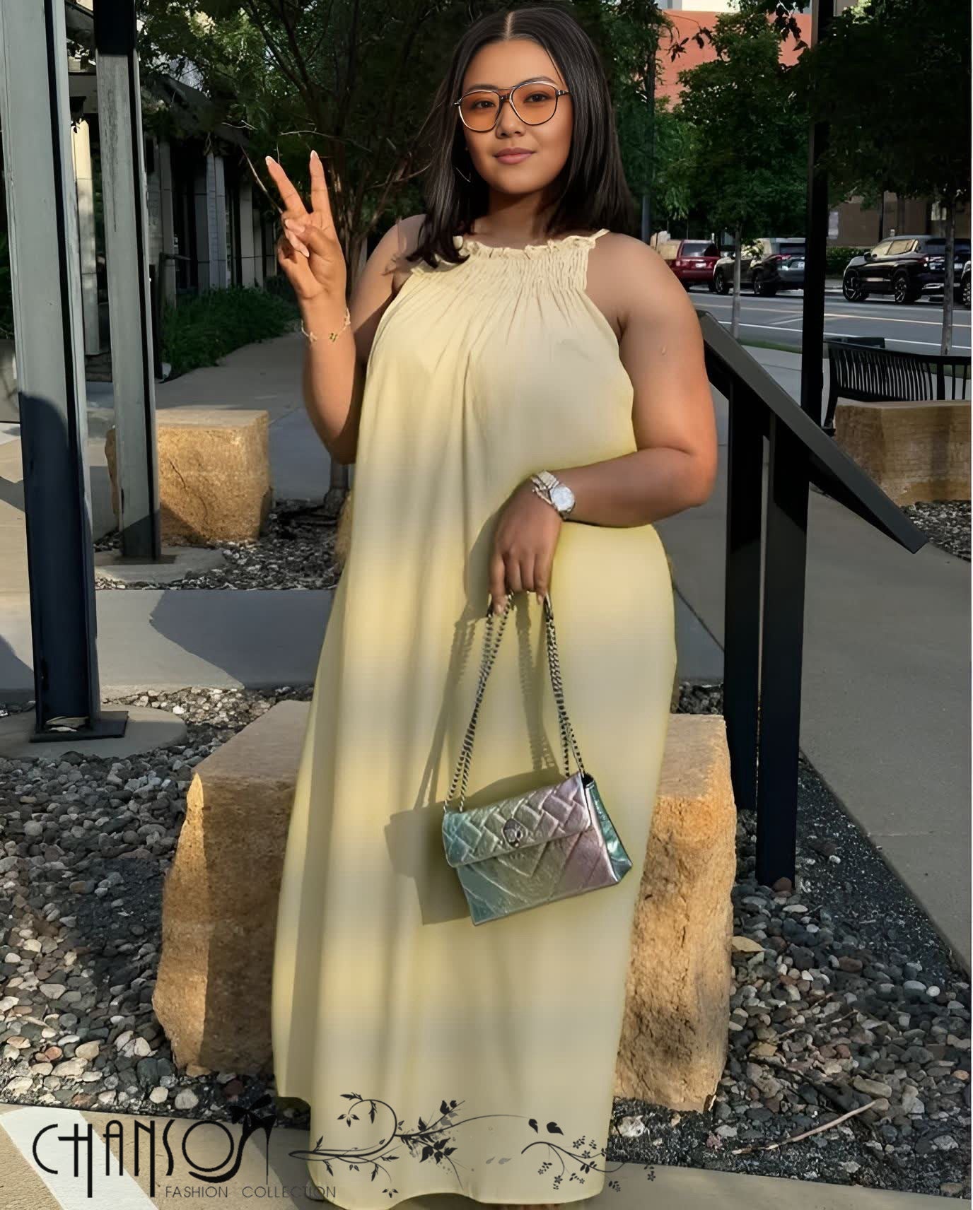 Beige sleeveless maxi dress with gathered round neckline and flowing skirt
