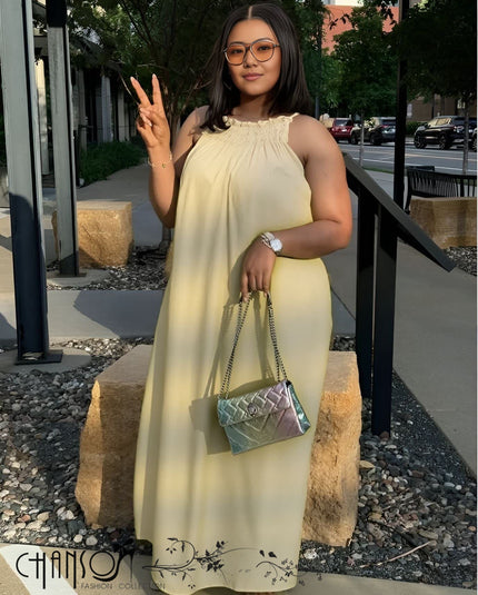 Beige sleeveless maxi dress with gathered round neckline and flowing skirt