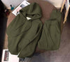 Olive-green hoodie and matching sweatpants set with drawstring hood and pockets