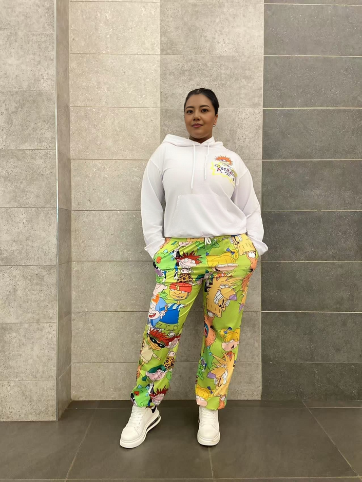 White cartoon hoodie set with green character-print jogger pants, drawstring hood.