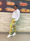 White cartoon hoodie set with bright green character-print pants and kangaroo pocket.