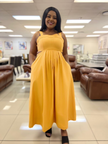 Yellow pleated sleeveless midi dress with square neckline and cinched high waist