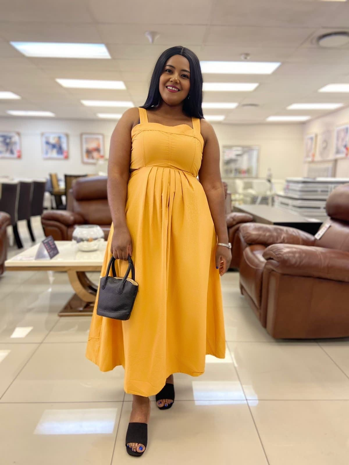Yellow pleated midi dress, sleeveless bodice with high waist and full skirt