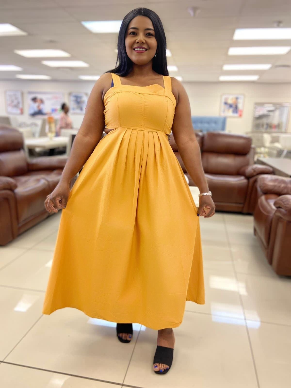 Yellow sleeveless pleated midi dress with gathered bodice and flared skirt