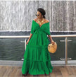 Green off-shoulder tiered maxi dress with draped V neckline and ruffle skirt