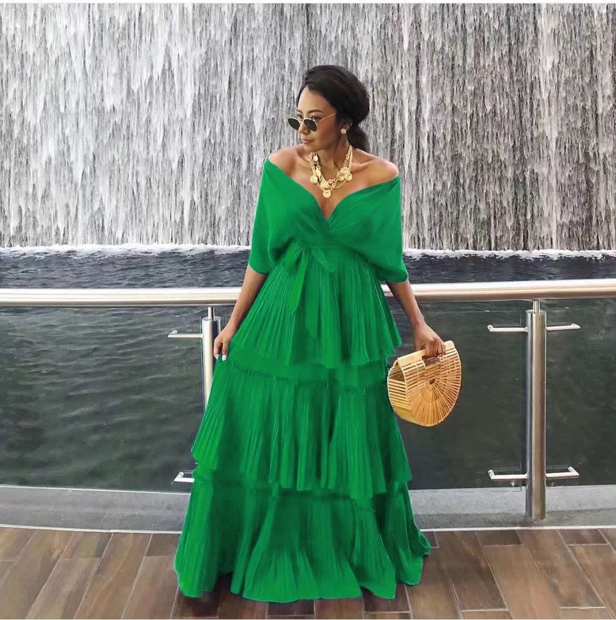 Green off-shoulder tiered maxi dress with draped V neckline and ruffle skirt
