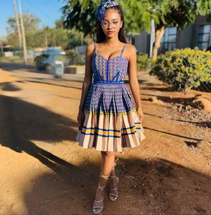 Ethnic mini dress with pleated patchwork hem, multicolor blue pink pattern