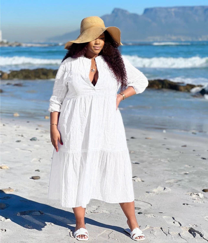 White tiered maxi dress with V-neck and three-quarter sleeves, keyhole front