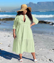 Light green tiered maxi dress with V-neck and three-quarter sleeves, keyhole front