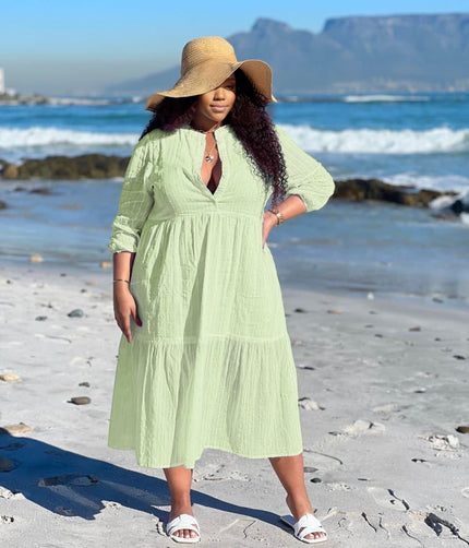 Light green tiered maxi dress with V-neck and three-quarter sleeves, keyhole front