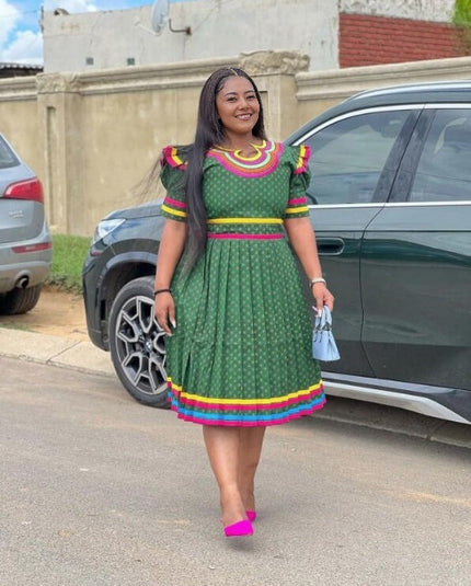 Green puff-sleeve dress with multicolor yoke and striped hem trim, short gathered skirt