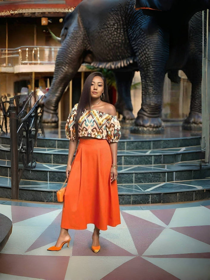Off-shoulder geometric midi dress with orange skirt and puff sleeves