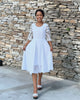 White lace midi dress with scalloped neckline, 3/4 flare sleeves, full skirt