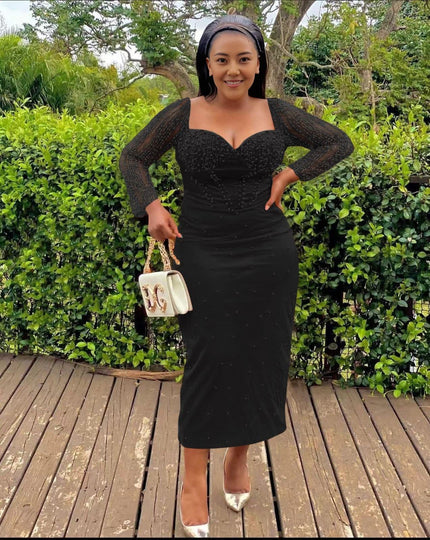 Black sequin sheath midi dress with sweetheart neckline and long sleeves