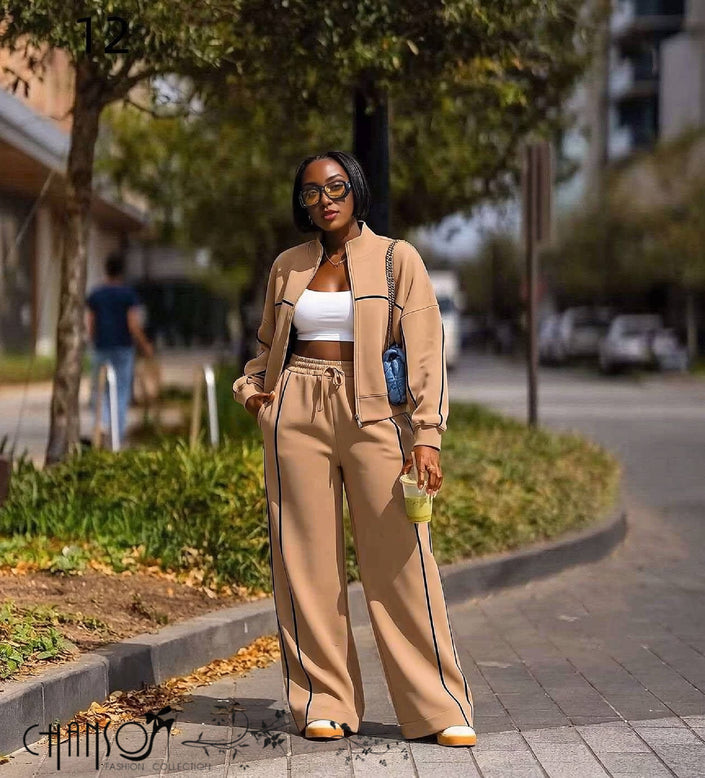 Tan tracksuit with zip-up jacket and matching wide-leg pants, dark contrast piping and stripe