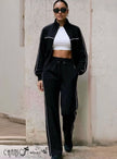 Black tracksuit with zip-up jacket and matching pants, white contrast stripe and drawstring waist