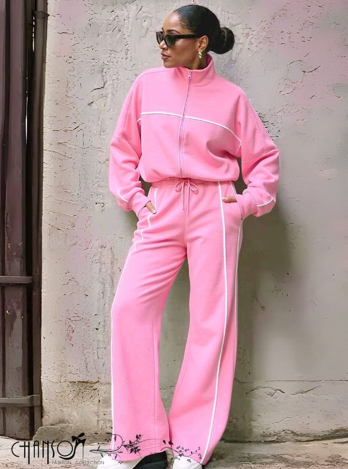 Pink tracksuit with zip-up jacket and matching pants, white contrast piping and drawstring waist