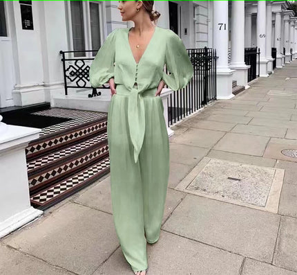 Light green V-neck puff-sleeve jumpsuit with adjustable waist tie and wide-leg pants