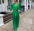 Green V-neck puff-sleeve jumpsuit with adjustable waist tie and wide-leg pants
