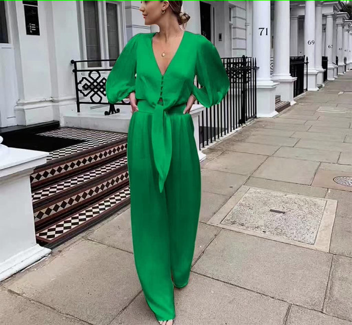 Green V-neck puff-sleeve jumpsuit with adjustable waist tie and wide-leg pants