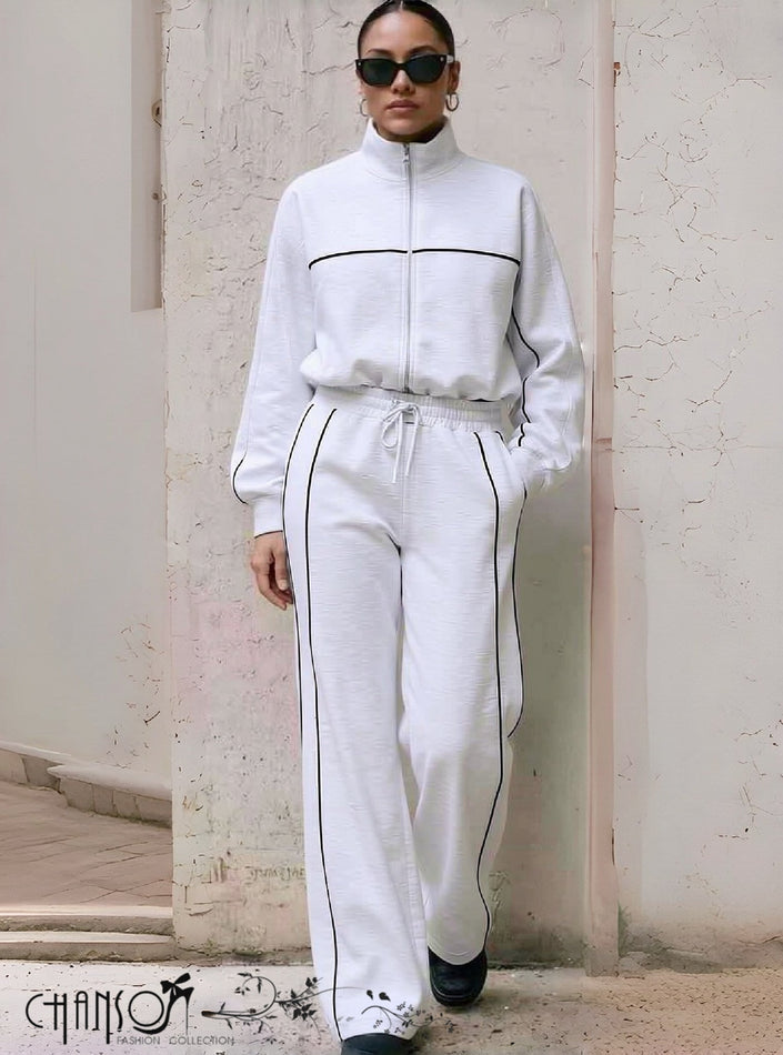 White tracksuit with zip-up jacket and matching pants, dark contrast piping and drawstring