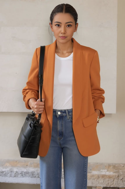 Rust orange blazer jacket with notched lapels and patch pockets, long sleeves.