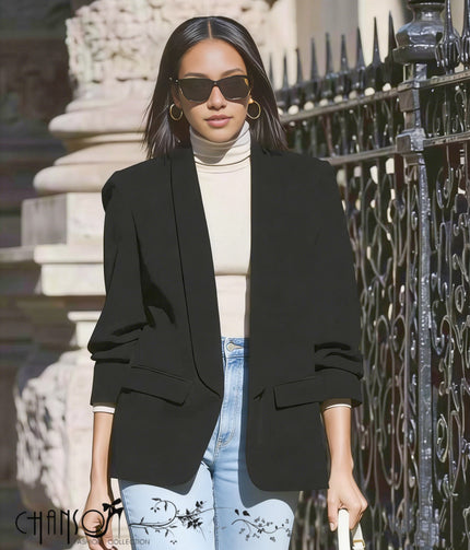 Black blazer jacket with notched lapels and patch pockets, tailored fit.