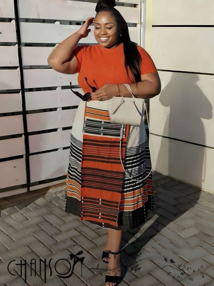 Geometric stripe print dress with orange short-sleeve top and black striped skirt