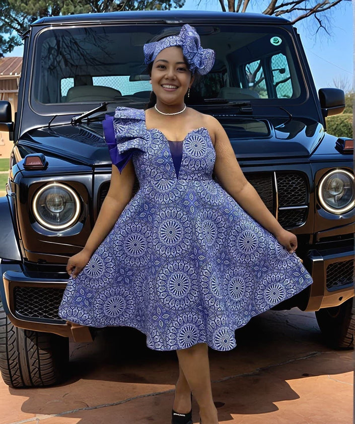 One-shoulder African print ruffle dress in blue with circular patterned flare skirt
