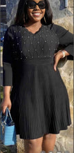 Dark knit midi dress with pleated skirt and bead-studded diamond yoke